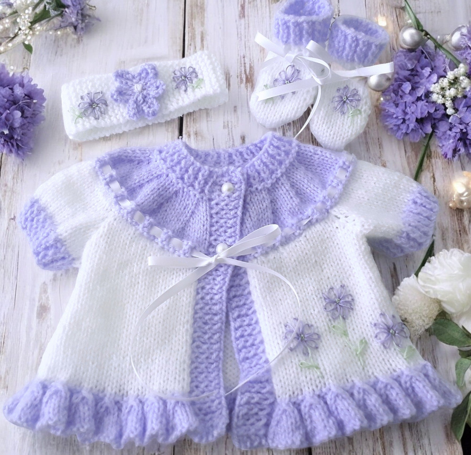 gemknits4kids hand knitted baby girl outfit in softwhite & Lilac with floral embroidery, including cardigan, headband, boots