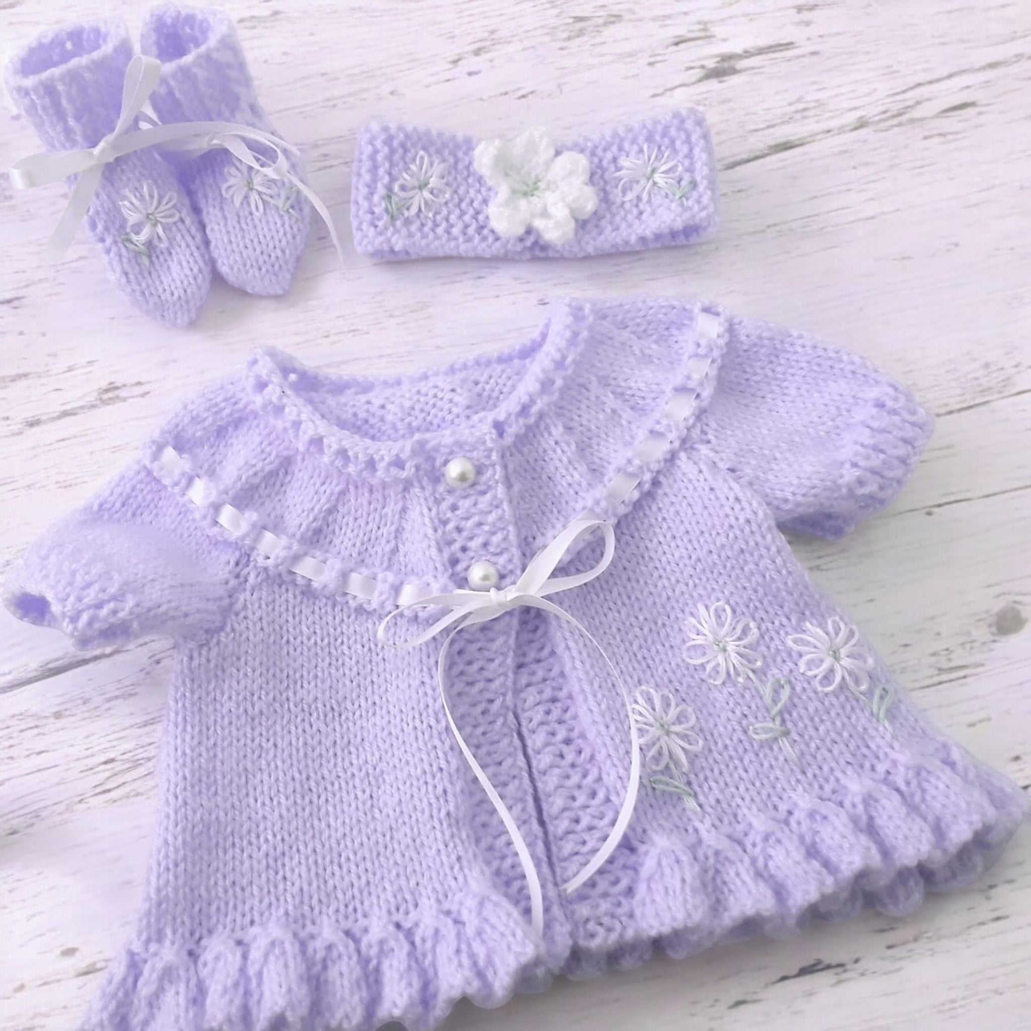 gemknits4kids hand knitted baby girl outfit in soft lilac with floral embroidery, including cardigan, headband, boots