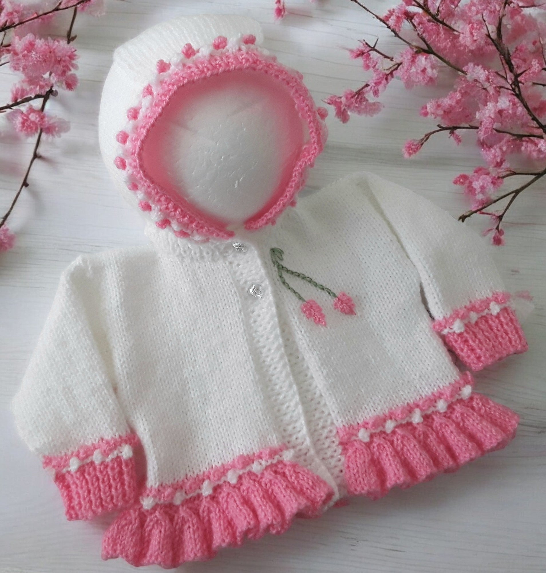 Designer hand knitted baby girl frilly cardigan with hood, floral embroidery in deep pink