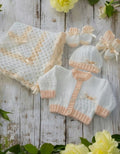 gemknits4kids hand-knitted white and peach baby girl 5-piece set with cardigan, hat, booties, mittens, and blanket.