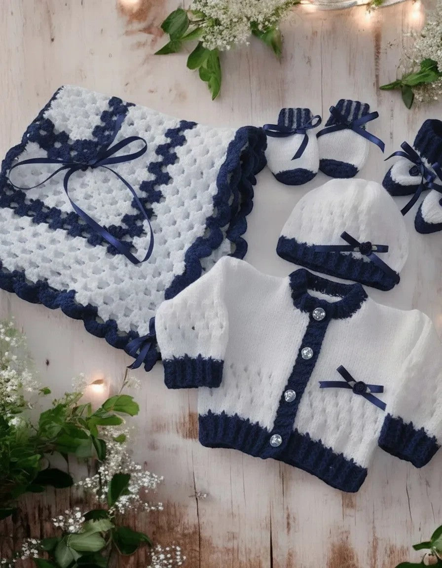gemknits4kids hand-knitted white and navy baby girl outfit set with cardigan, hat, booties, mittens, and blanket.