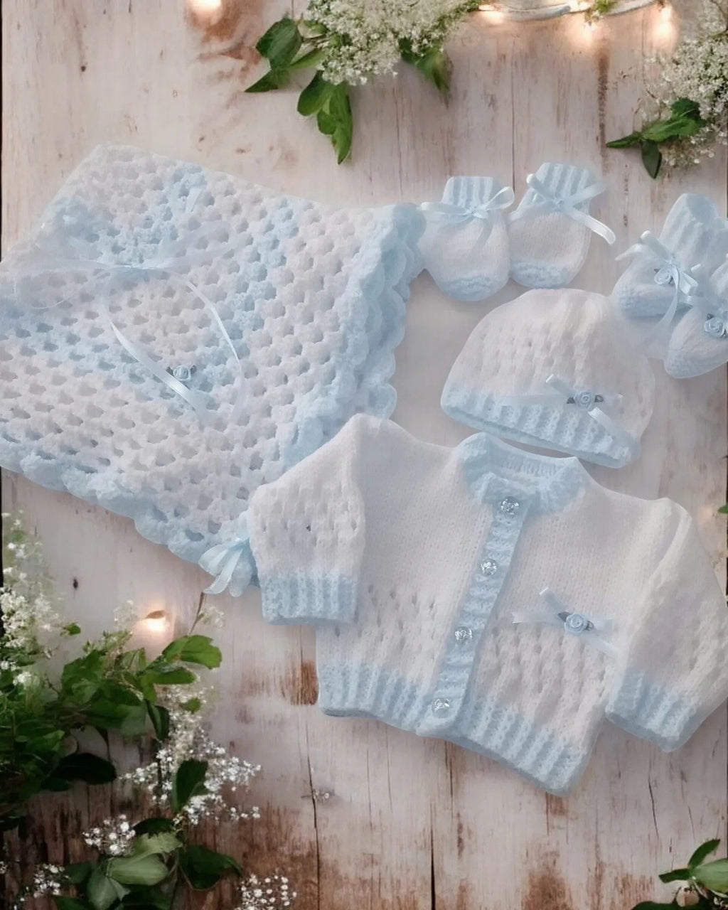 gemknits4kids hand-knitted 5-piece baby set in white and blue with cardigan, hat, booties, mittens, and pram blanket.