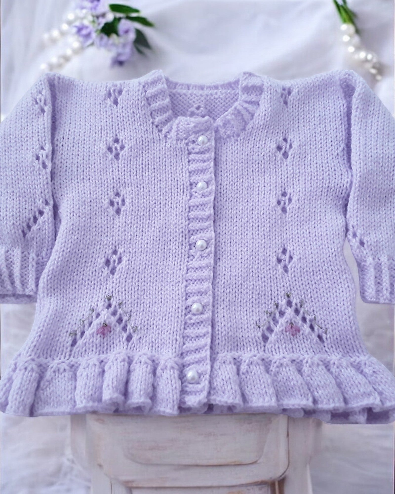 gemknits4kids lavender hand-knitted girls cardigan with lace pattern, silk flower embroidery, and pearl buttons.