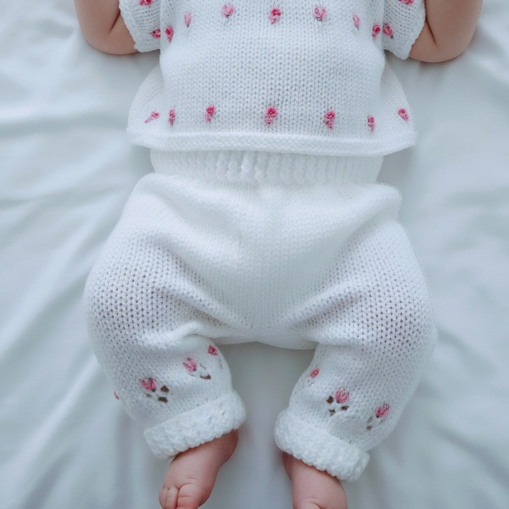 gemknits4kids white hand knitted baby leggings with delicate pink floral embroidery on soft acrylic yarn