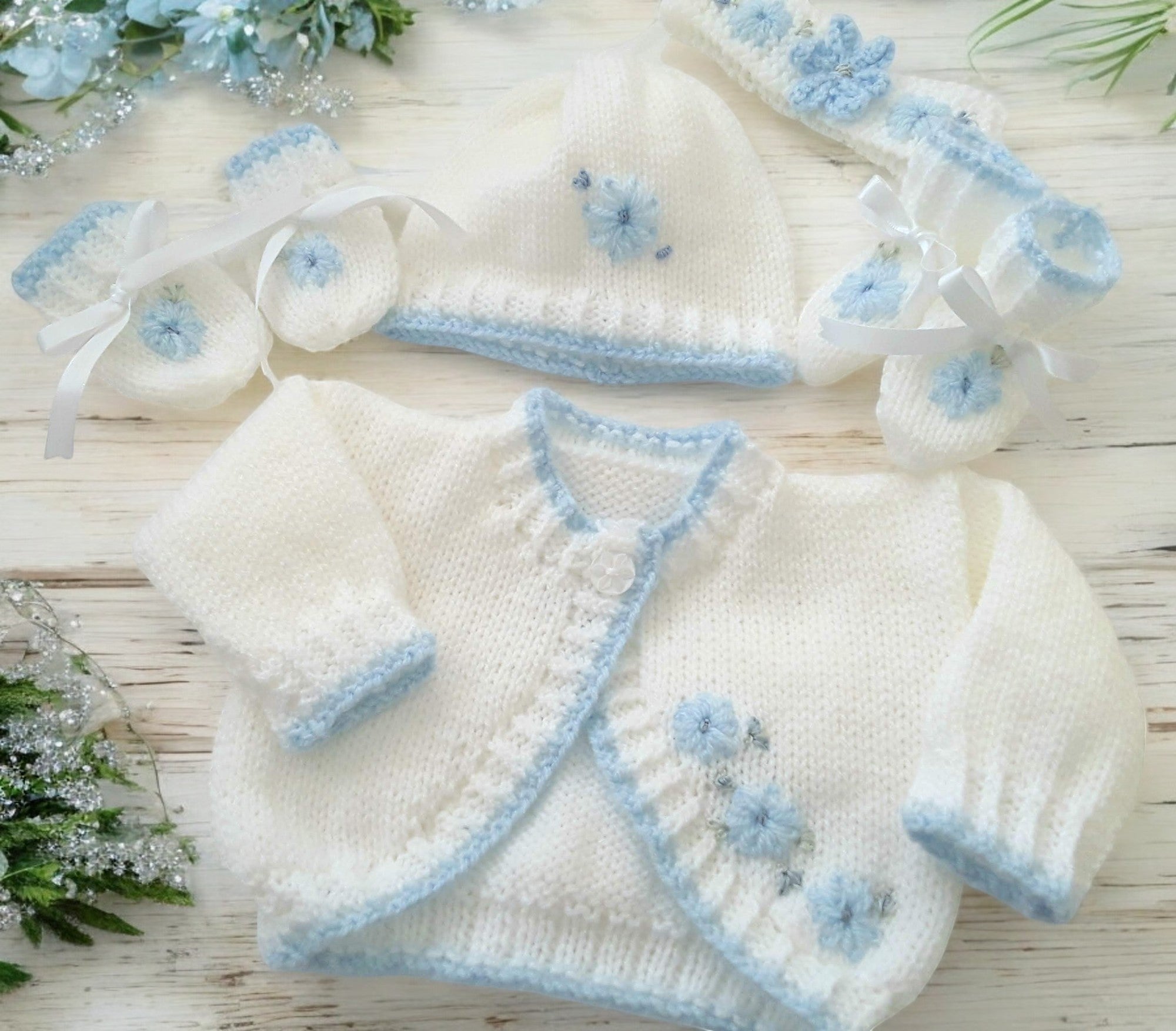 gemknits4kids white hand-knitted bolero cardigan with blue embroidery