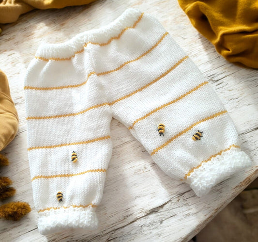 gemknits4kids white knitted baby leggings with yellow stripes and small bumble bee embroidery details