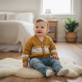 Hand-knitted baby boy V-neck cardigan in soft mustard premium yarn, featuring a classic button-front design. Handmade boutique knitwear for newborns, babies and toddlers, ideal for everyday wear, special occasions and baby gifts